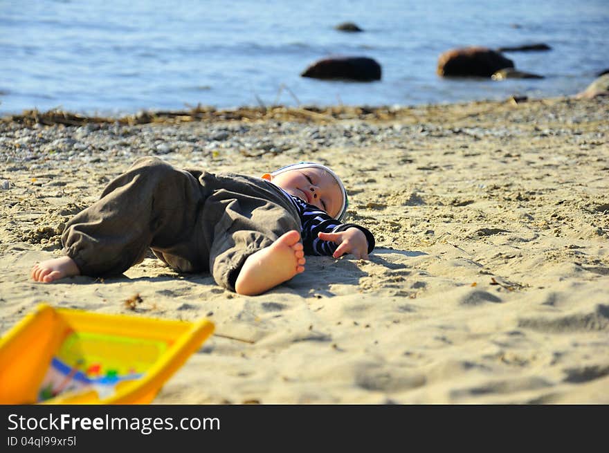 Cute small boy playing on a beach. Cute small boy playing on a beach