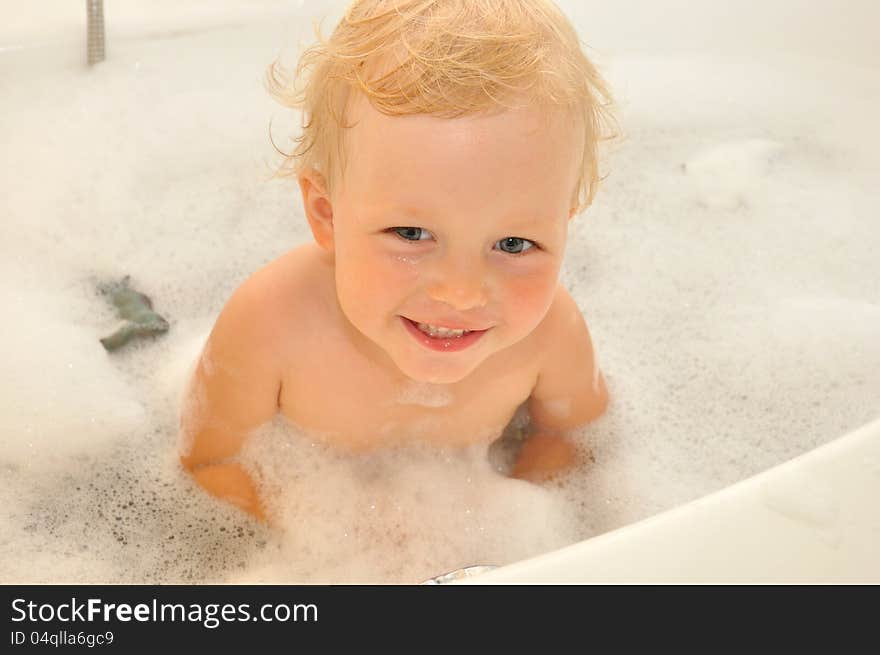 Happy Child Bathes In A Bathroom