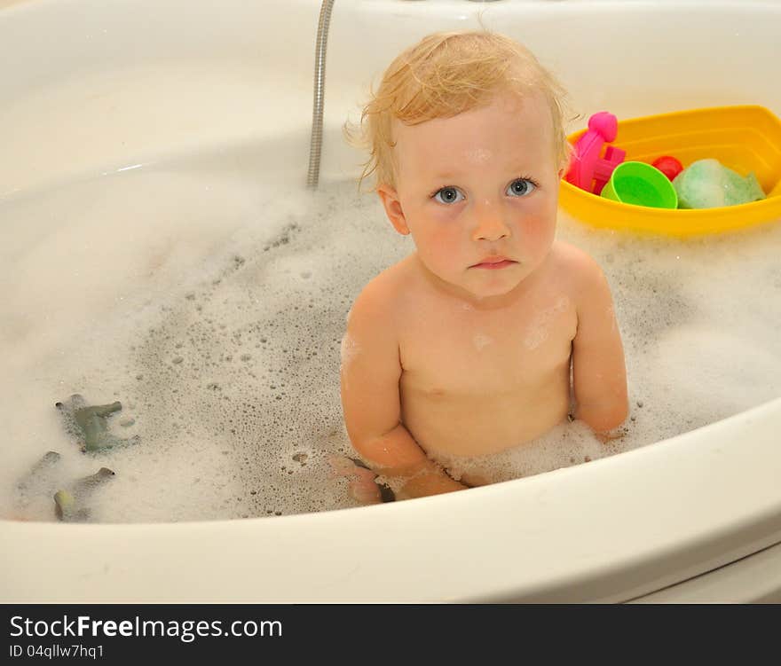 Happy boy bathes in a bathroom. Happy boy bathes in a bathroom