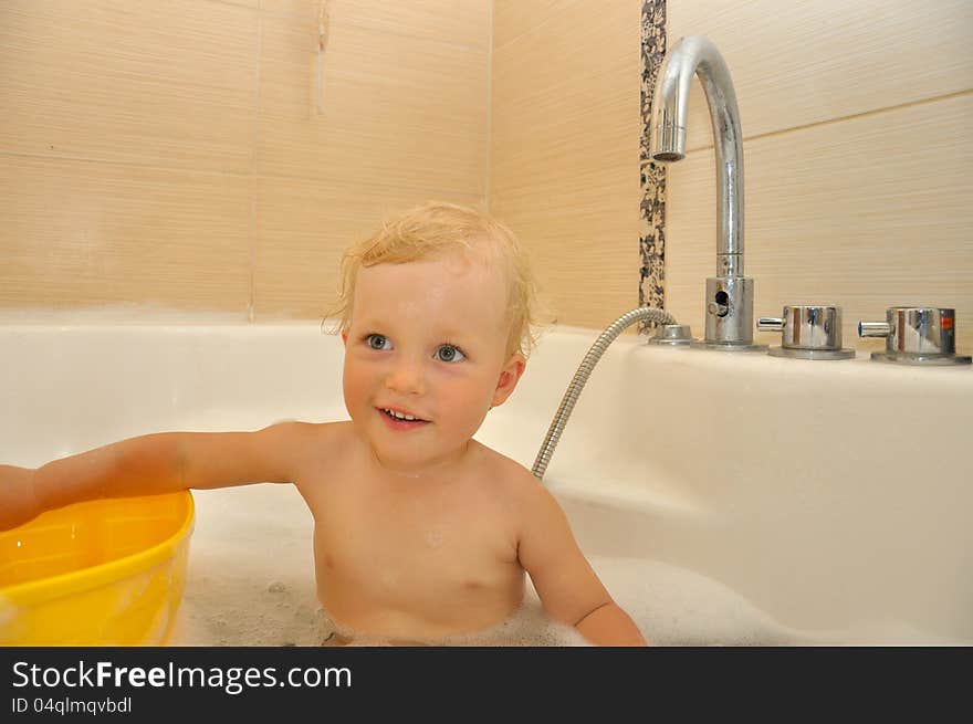 Happy boy bathes in a bathroom. Happy boy bathes in a bathroom