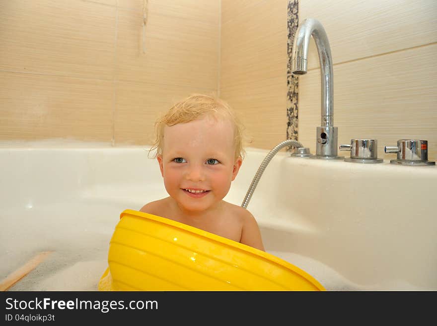 Happy boy bathes in a bathroom. Happy boy bathes in a bathroom