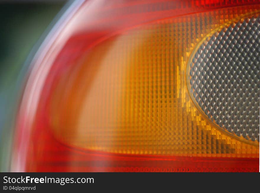 Detail of red and orange rear light of car