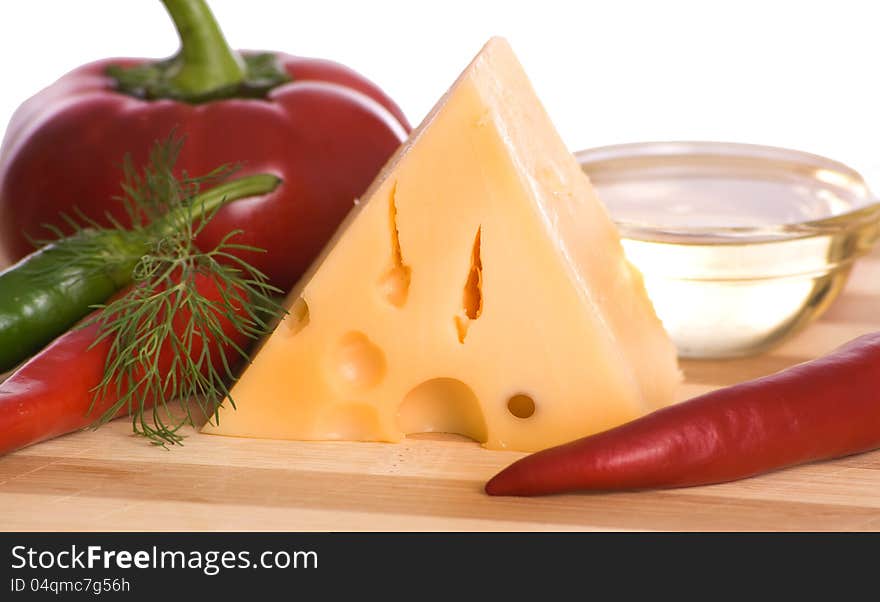 Cheese and pepper on wooden board