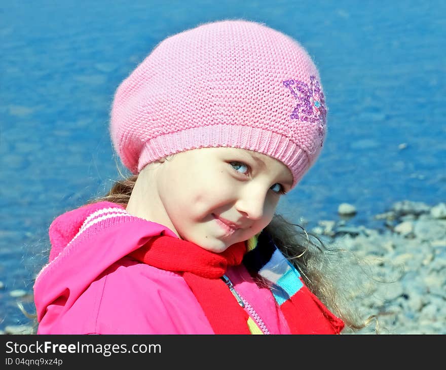 The smiling girl on the background of blue water. The smiling girl on the background of blue water