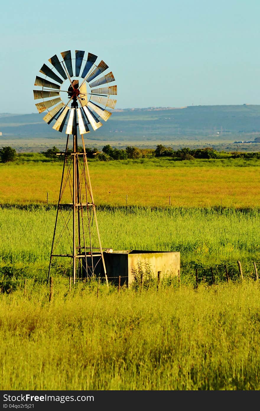 Landscape with windmill water pump on a farm westerncape south africa