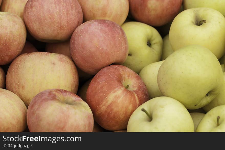 A pile of apples for sale at a market.