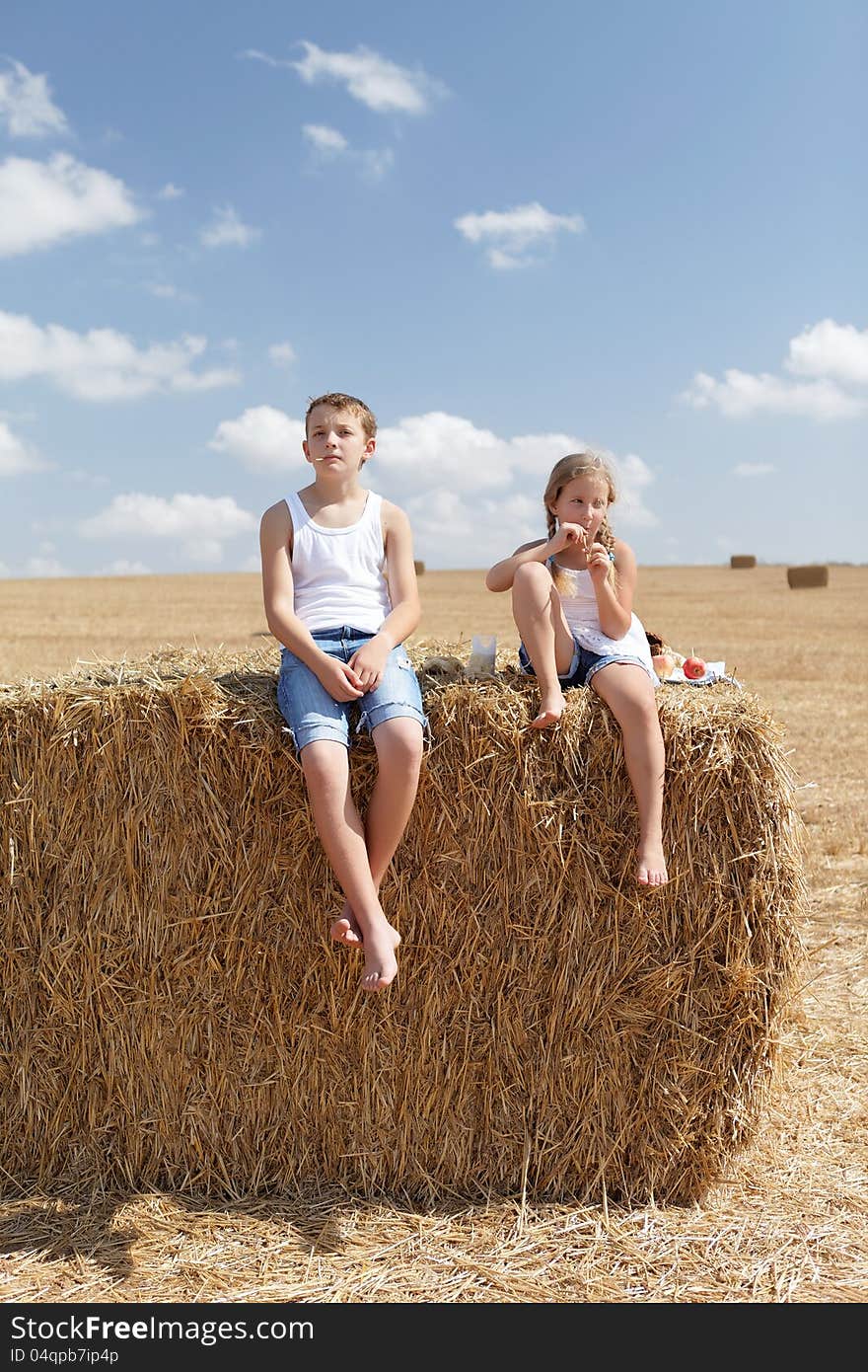 Brother and sister in the hay in the countryside