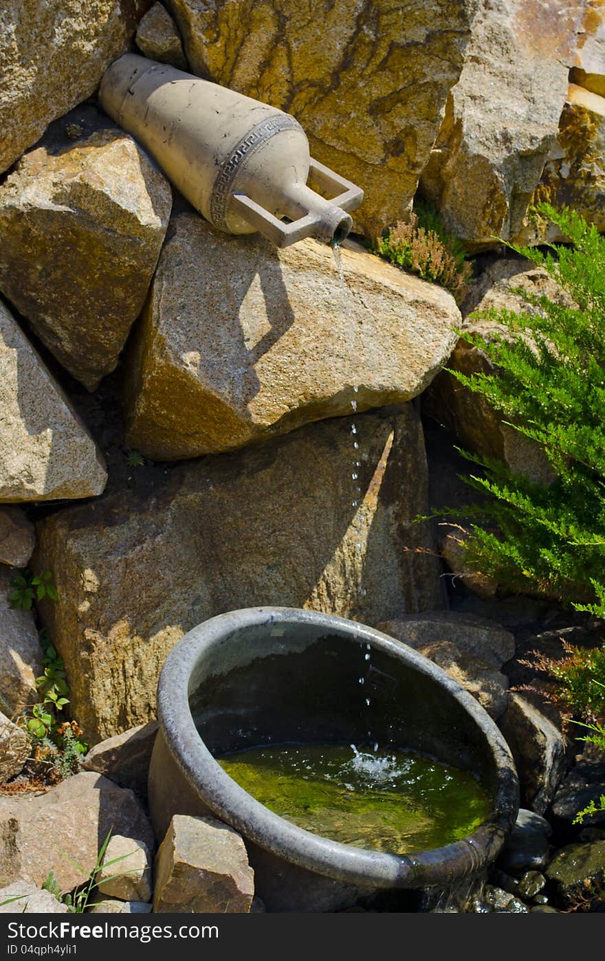 Fine small falls with green stones below