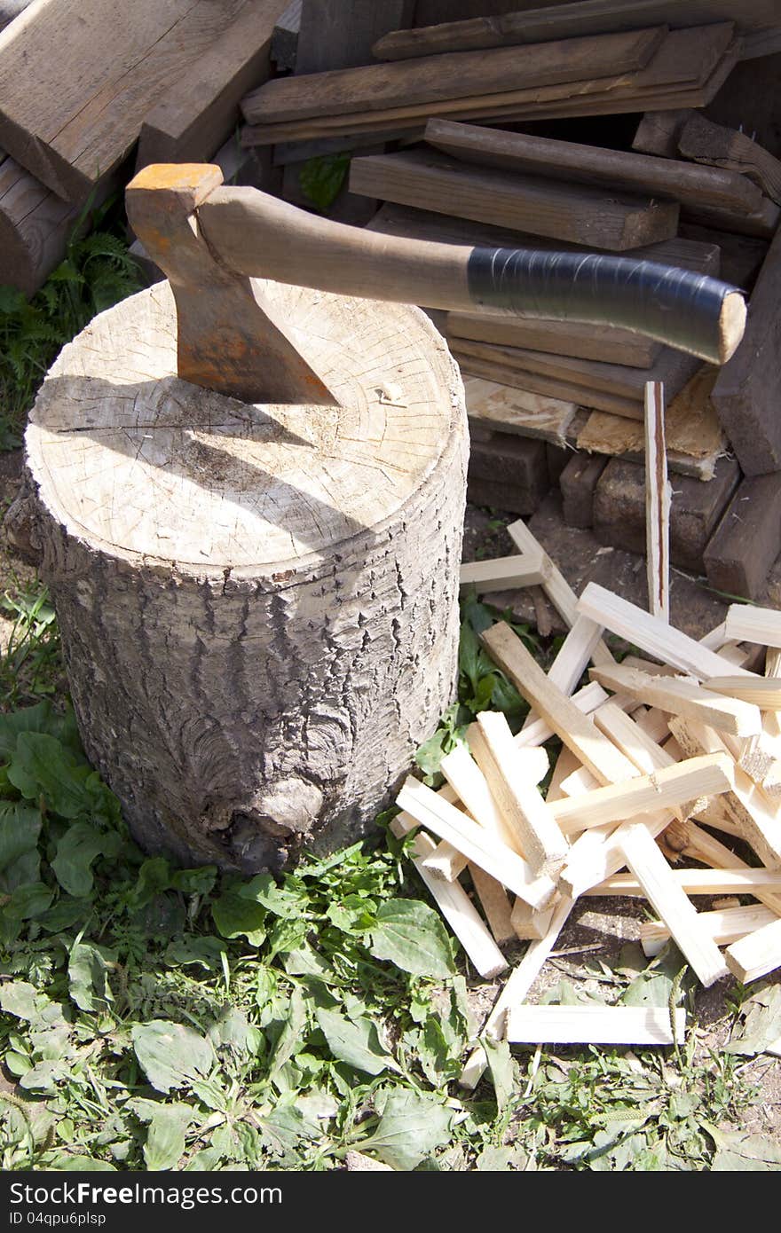 Axe on Log splitter and pegs closeup. Axe on Log splitter and pegs closeup