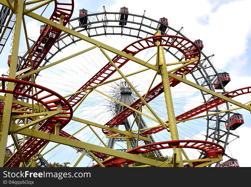 Roller coaster and large ferris wheel in Prater, Vienna, Austria