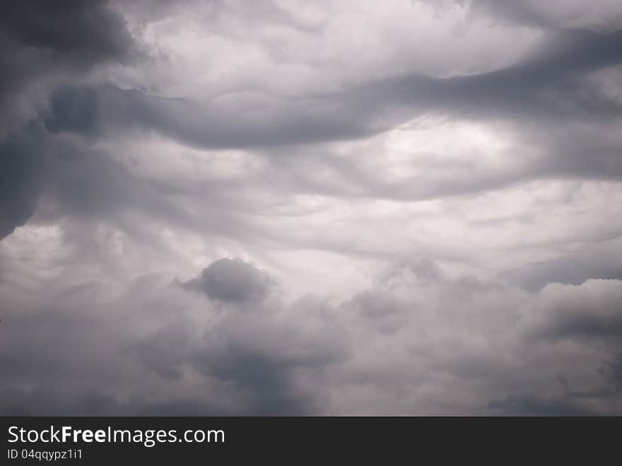 Dense, dark storm clouds with an interesting pattern. Dense, dark storm clouds with an interesting pattern