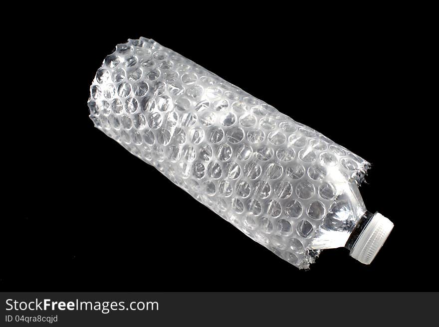 Bottle of water surrounded in bubble wrap. Bottle of water surrounded in bubble wrap