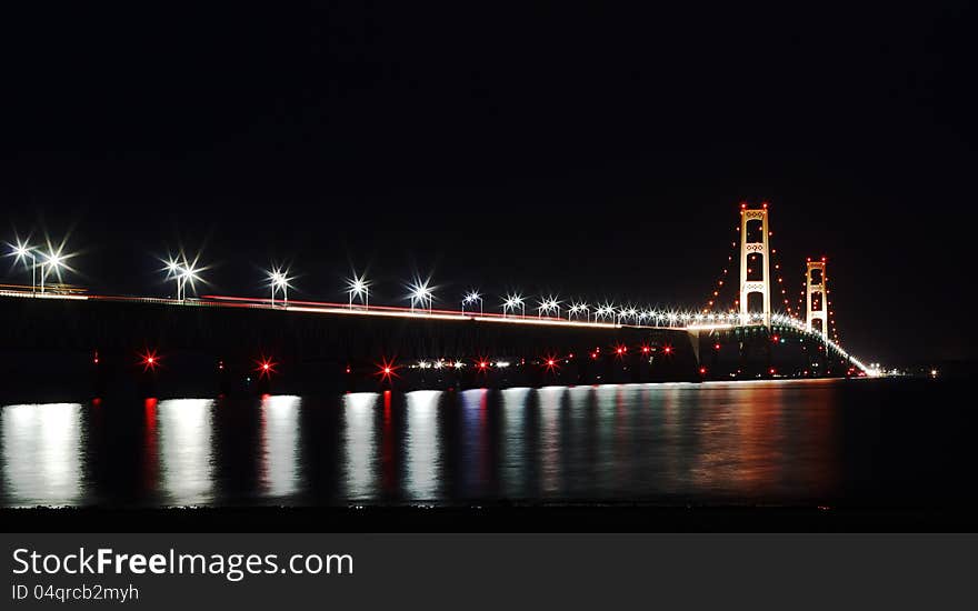 The Mackinac Bridge is located on Interstate 75 in northern Michigan at the Straits of Mackinac. The bridge connects Michigan's upper and lower peninsulas. The Mackinac Bridge is located on Interstate 75 in northern Michigan at the Straits of Mackinac. The bridge connects Michigan's upper and lower peninsulas.