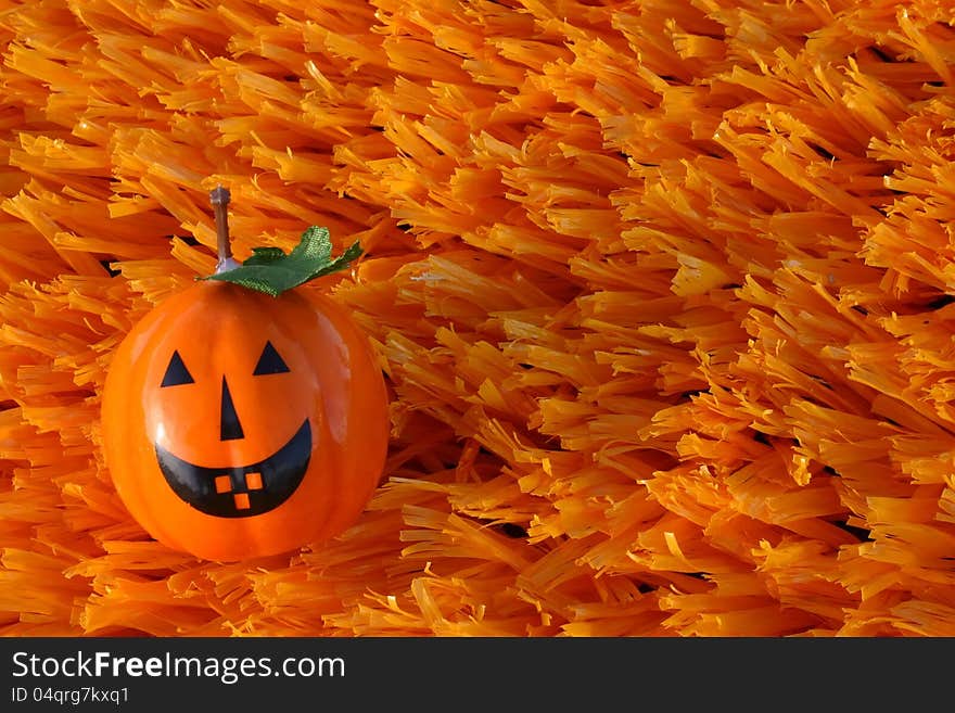 Jack-o-lantern on orange artificial turf. Jack-o-lantern on orange artificial turf