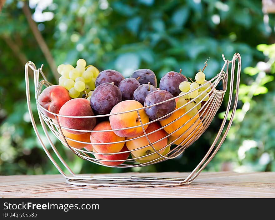 Mix of autumn fruits:grapes,plums,apple,peach