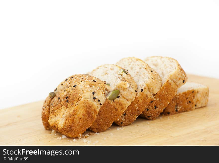 Fresh wholewheat bread with sunflower seeds Sesame and slices on black background. Fresh wholewheat bread with sunflower seeds Sesame and slices on black background