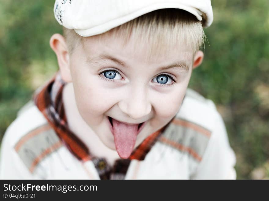 Boy Wearing A Cap Tongue