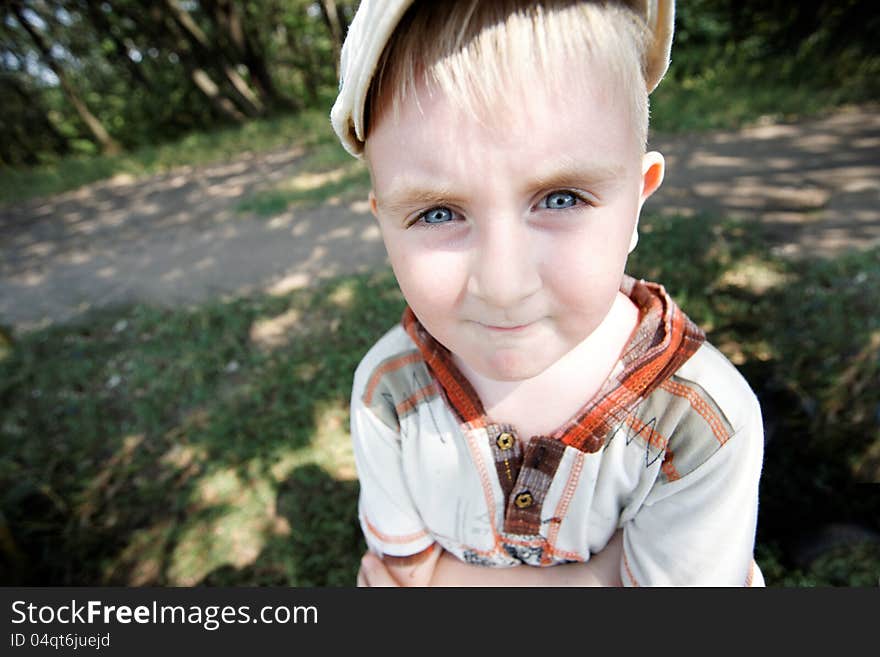 Boy Wearing A Cap Near The Forest