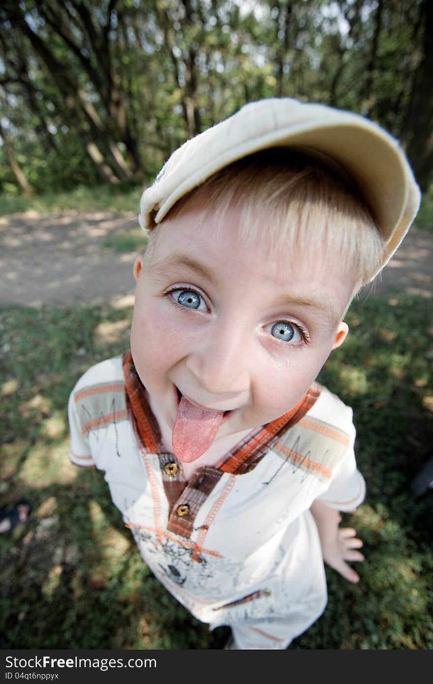 Boy grimacing near the forest