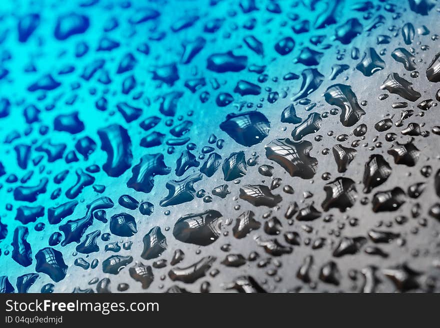 A close-up of water drops with a diagonal bicolor gradient. A close-up of water drops with a diagonal bicolor gradient