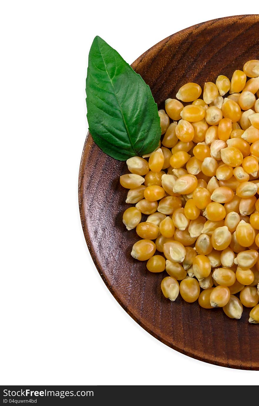 Plate with grain corn and basil leaf