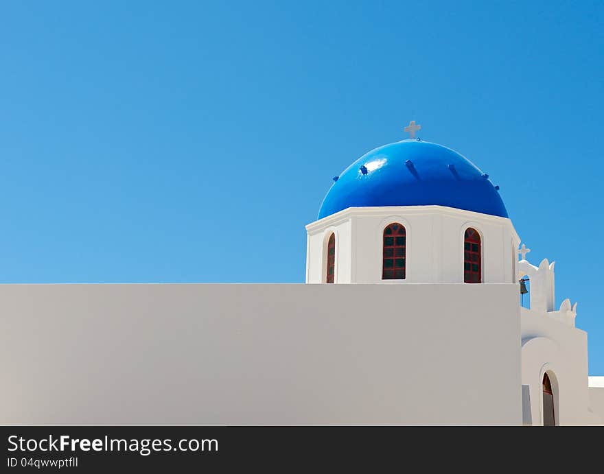 White, Christian church with blue dome, is shown in the background of blue sky. White, Christian church with blue dome, is shown in the background of blue sky.