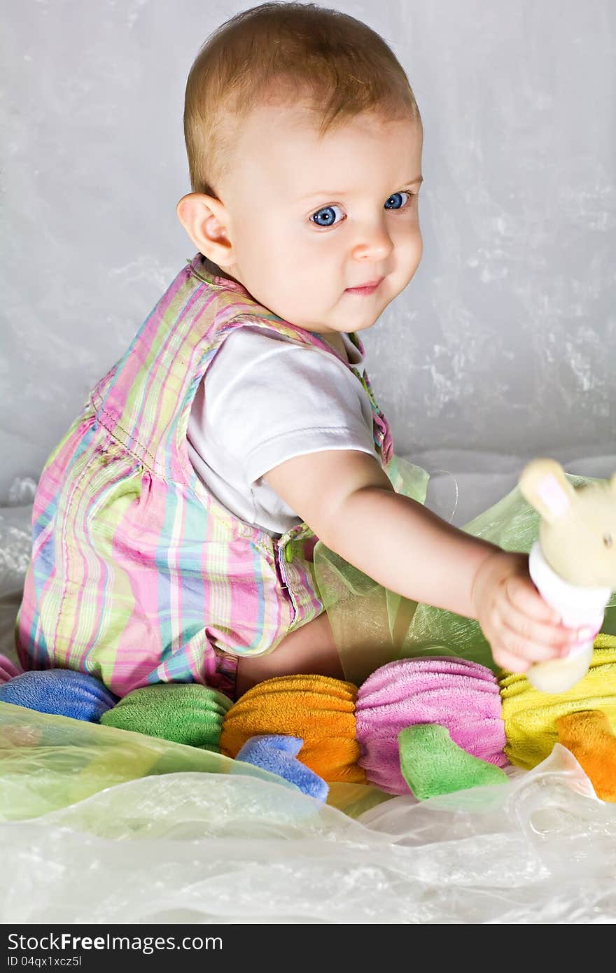 Little baby girl sitting and playing with toys. Little baby girl sitting and playing with toys