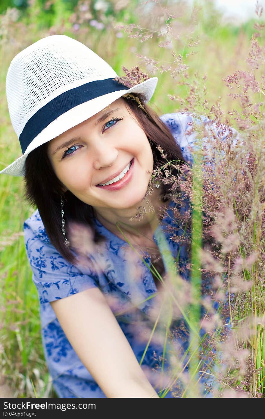 Smiling girl in hat on the meadow. Smiling girl in hat on the meadow