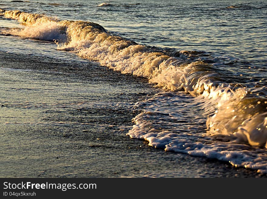 Waves on the coast of the sea at sunrise. Waves on the coast of the sea at sunrise