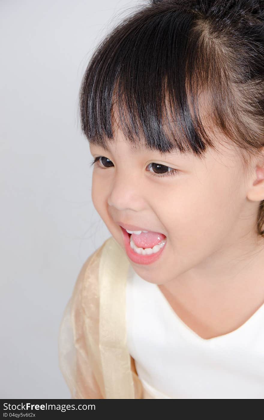 Little girl smiling in studio.