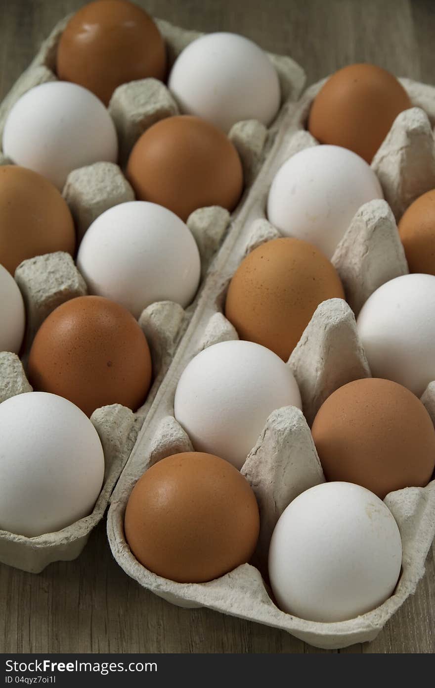 Eggs in the package on a wooden table. Eggs in the package on a wooden table