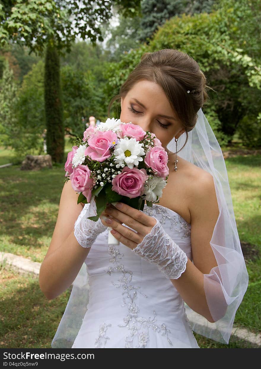 Beautiful bride in white dress with wedding bouquet. Beautiful bride in white dress with wedding bouquet