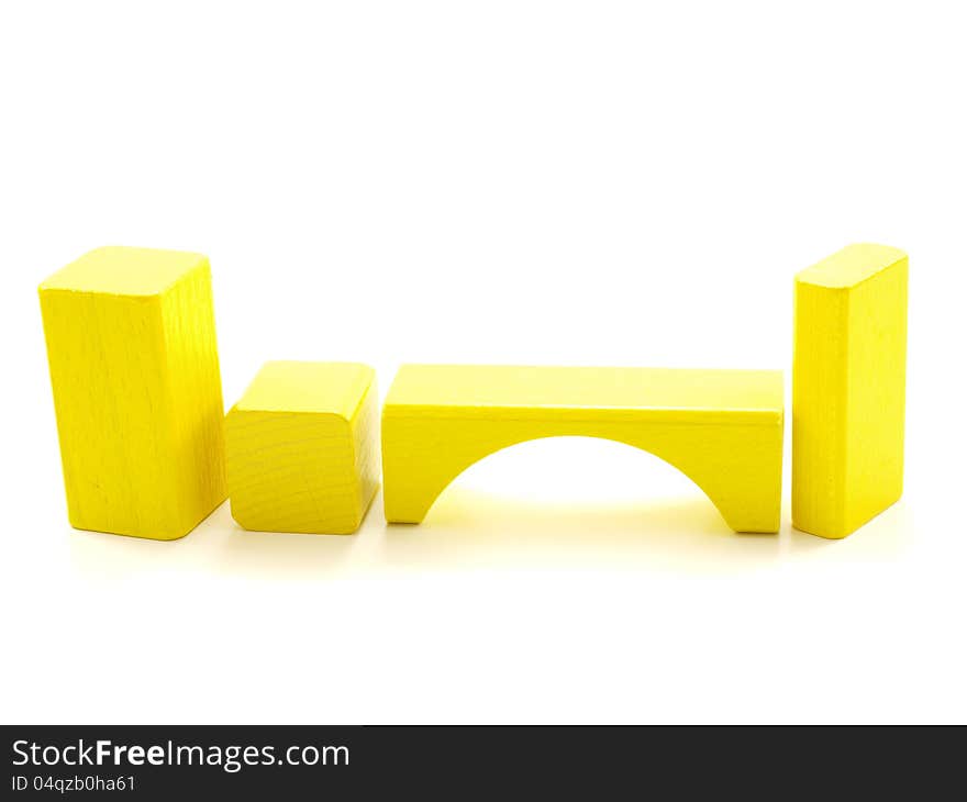 Wooden brick pieces of yellow color,  towards white. Wooden brick pieces of yellow color,  towards white