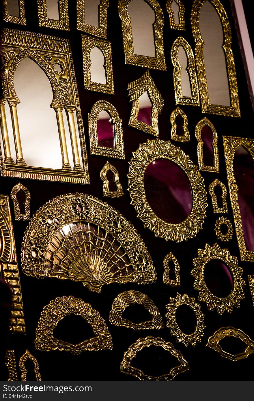 Close view of a bunch of beautiful golden mirrors hanging on the wall.