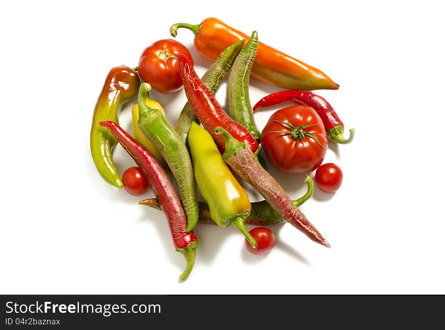 Homemade peppers and tomatoes on white background. Homemade peppers and tomatoes on white background