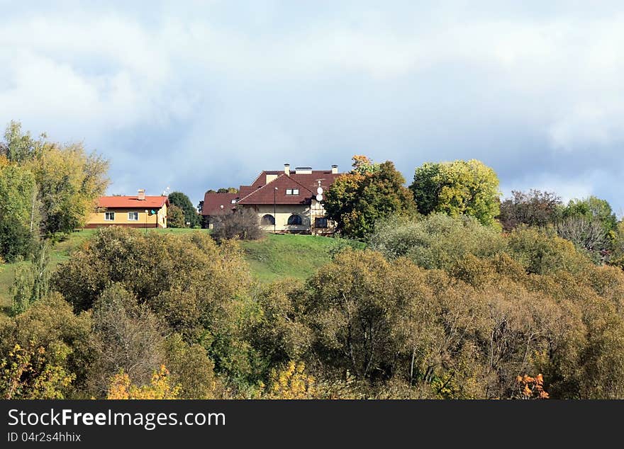 Two residential houses among trees on the hillside. Two residential houses among trees on the hillside