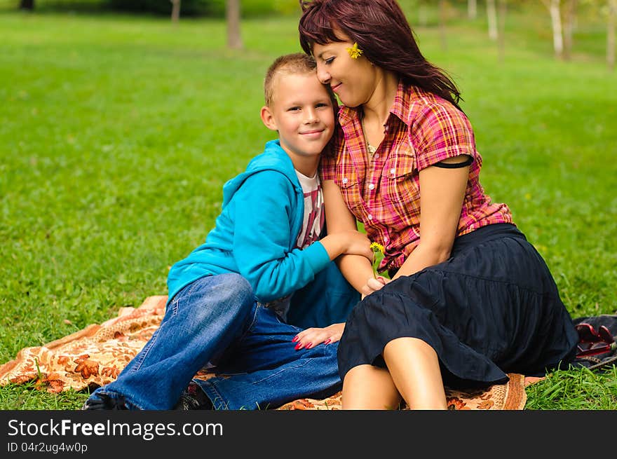 Mother and son play outside on field in the park. Mother and son play outside on field in the park