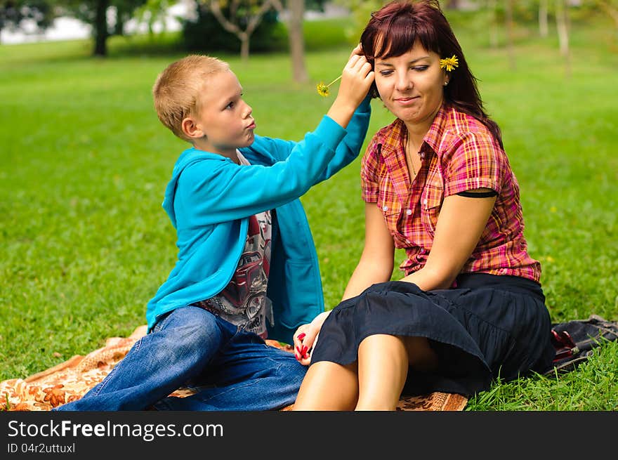 Mother and son play outside on field in the park. Mother and son play outside on field in the park