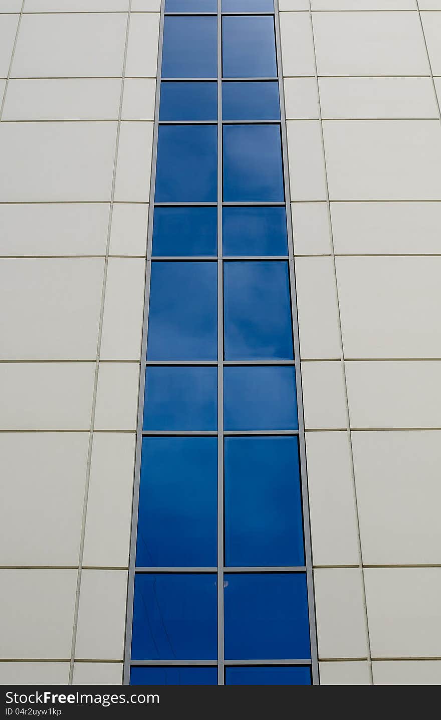 Blue sky reflected in the windows of office building. Blue sky reflected in the windows of office building