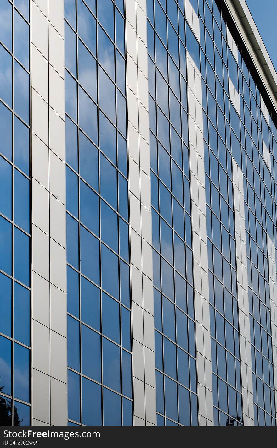 Blue sky reflected in the windows of office building. Blue sky reflected in the windows of office building