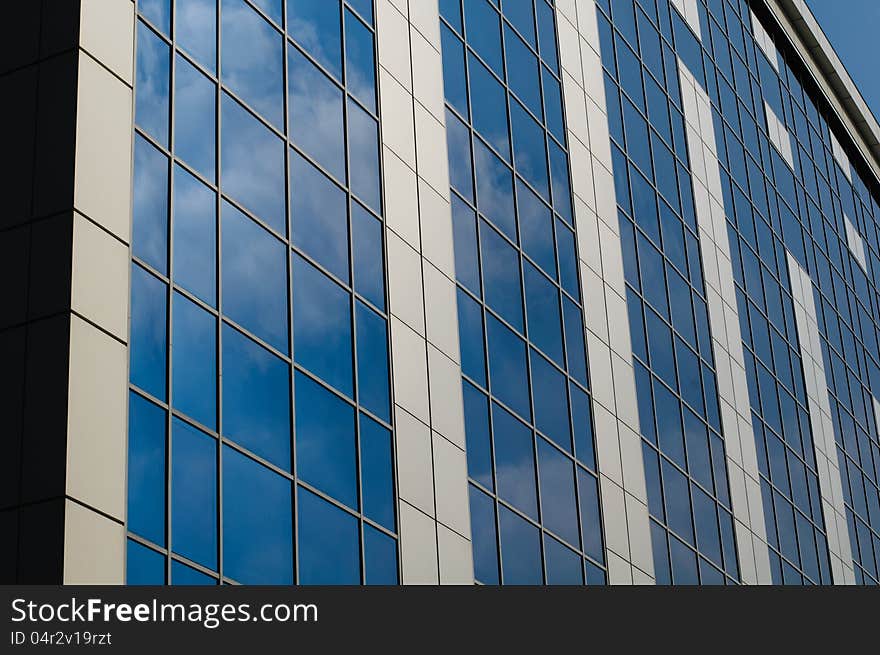 Blue sky reflected in the windows of office building. Blue sky reflected in the windows of office building