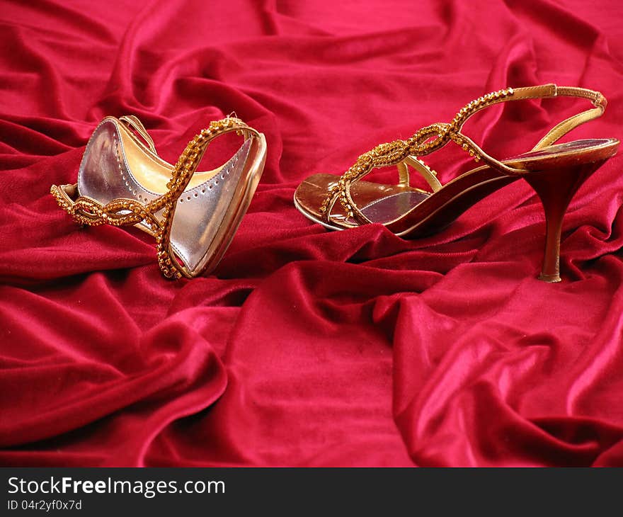 Photo of opened feminine loafer with jewels on background red velvet. Photo of opened feminine loafer with jewels on background red velvet.