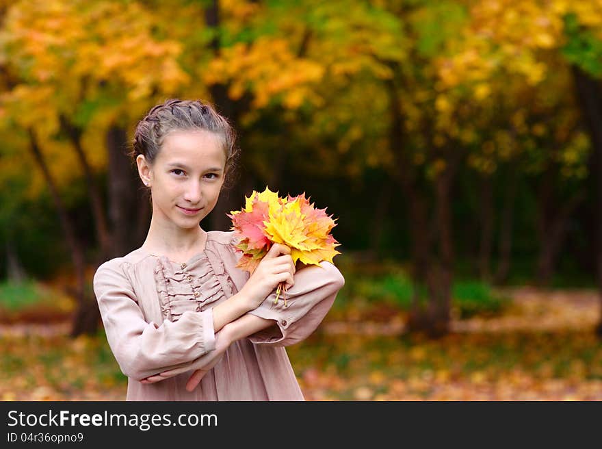 Portrait Of Girl With Maple Leaves