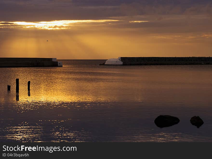 Beautiful sunrise In Kivik, golden sky and calm water. Beautiful sunrise In Kivik, golden sky and calm water