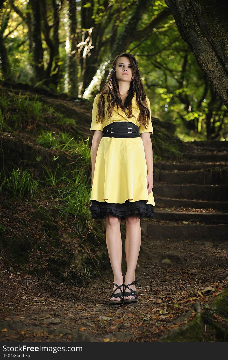 Girl standing in a forest.