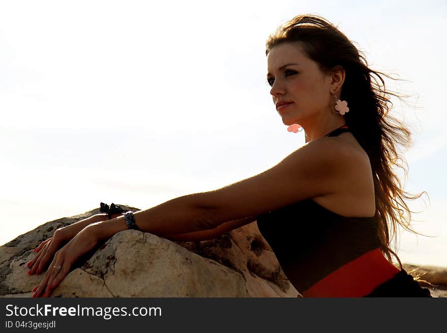 Beauty girl near the big stone