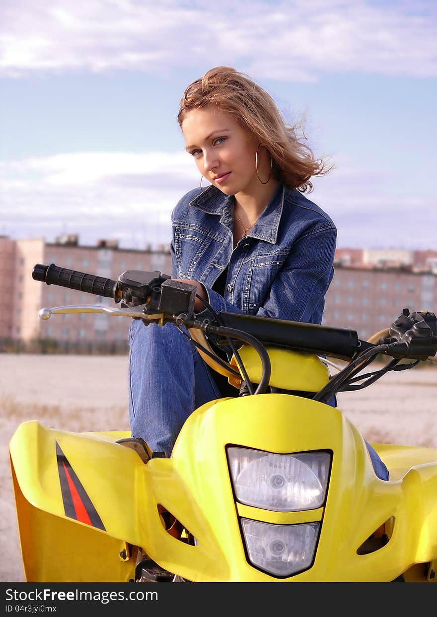 Beautiful blonde on sport quadrocycle on background of the city Nadym. Beautiful blonde on sport quadrocycle on background of the city Nadym.