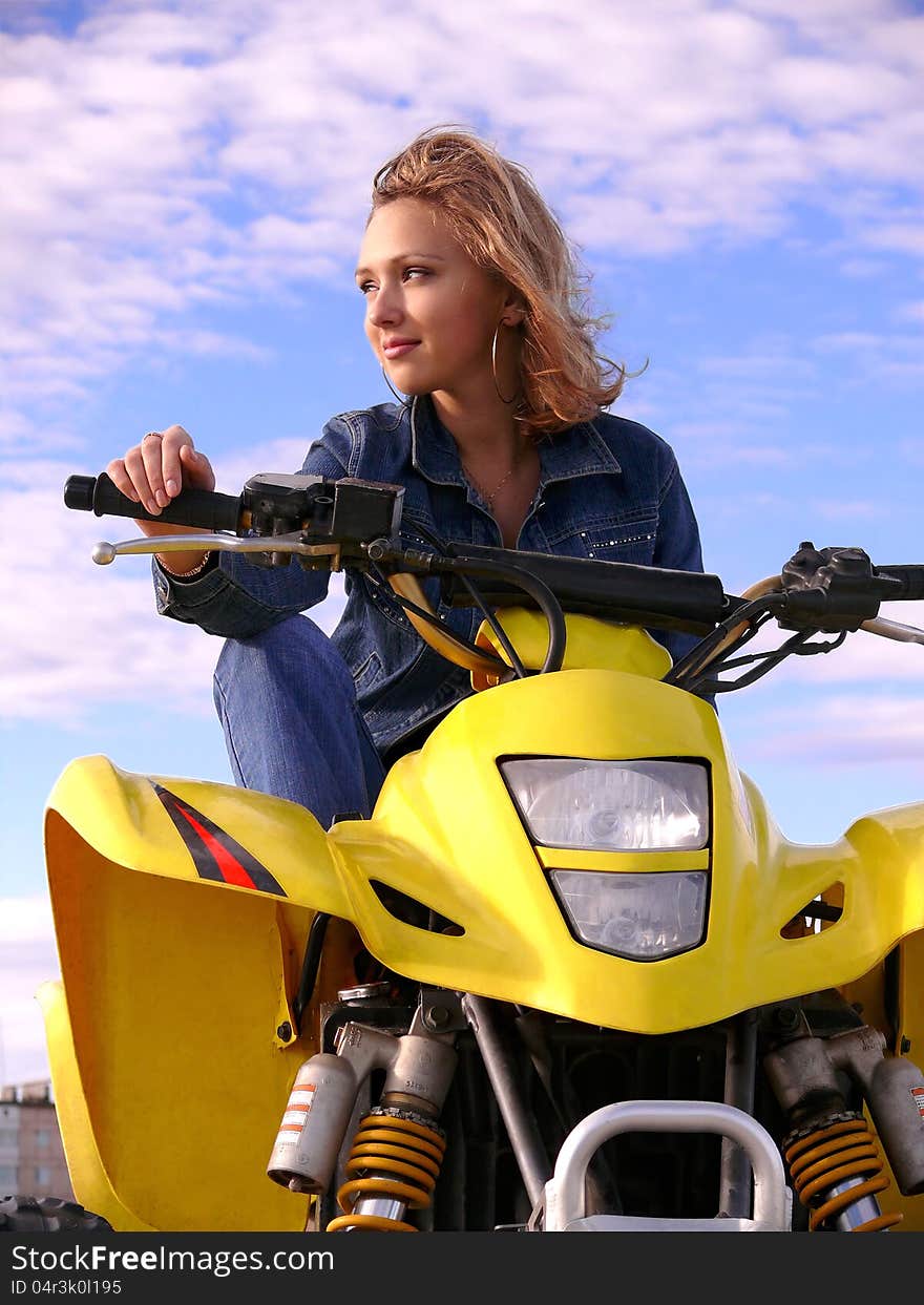 Beautiful blonde on sport quadrocycle on background of the blue sky. Beautiful blonde on sport quadrocycle on background of the blue sky.