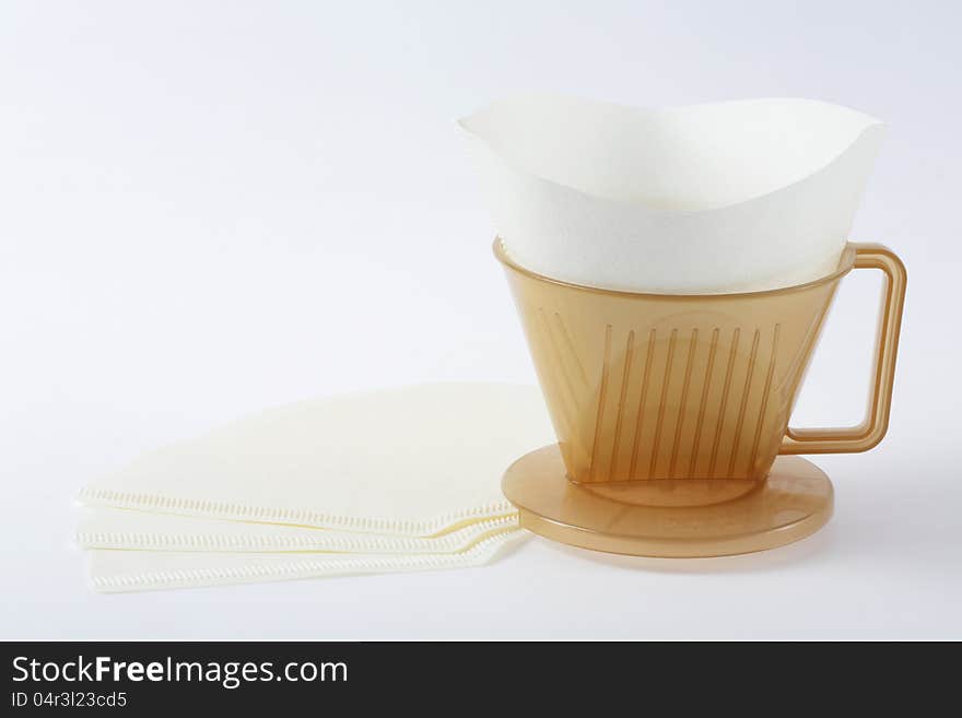 Three holes type coffee dripper with filter isolated on white