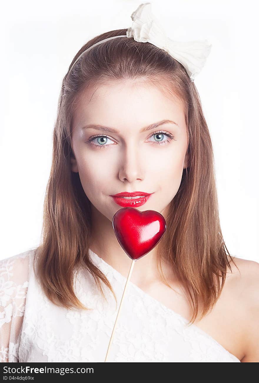 Beautiful smiling woman holding red heart shape symbol - valentines day concept. Beautiful smiling woman holding red heart shape symbol - valentines day concept